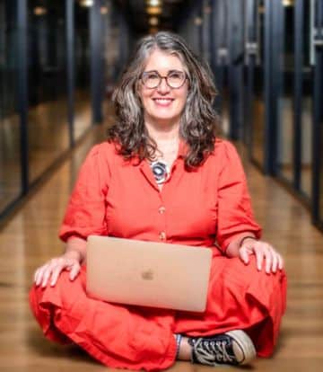 Rebecca Page-Chapman, business coach, sitting with laptop — contact page photo
